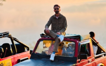 A tourist sits in an off-road jeep during a Batur sunrise tour.